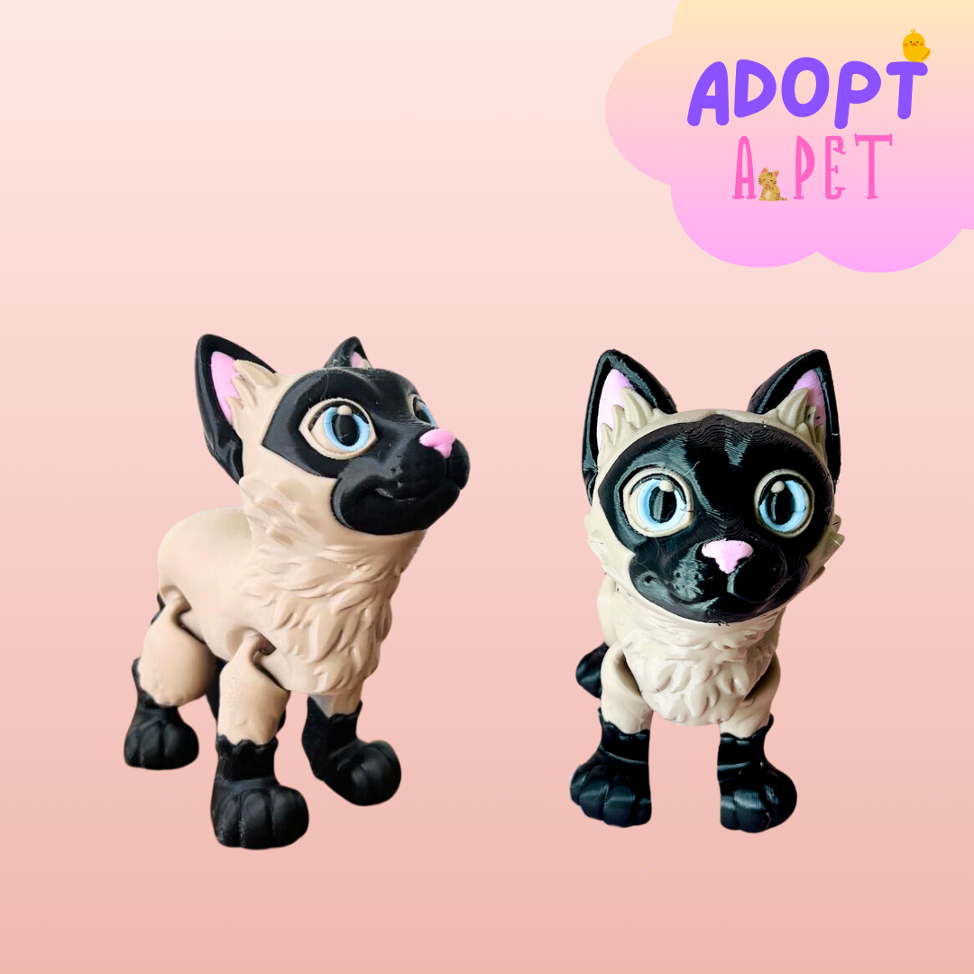 Two playful Siamese cat figurines with bright blue eyes and detailed fur, set against a soft pink background.