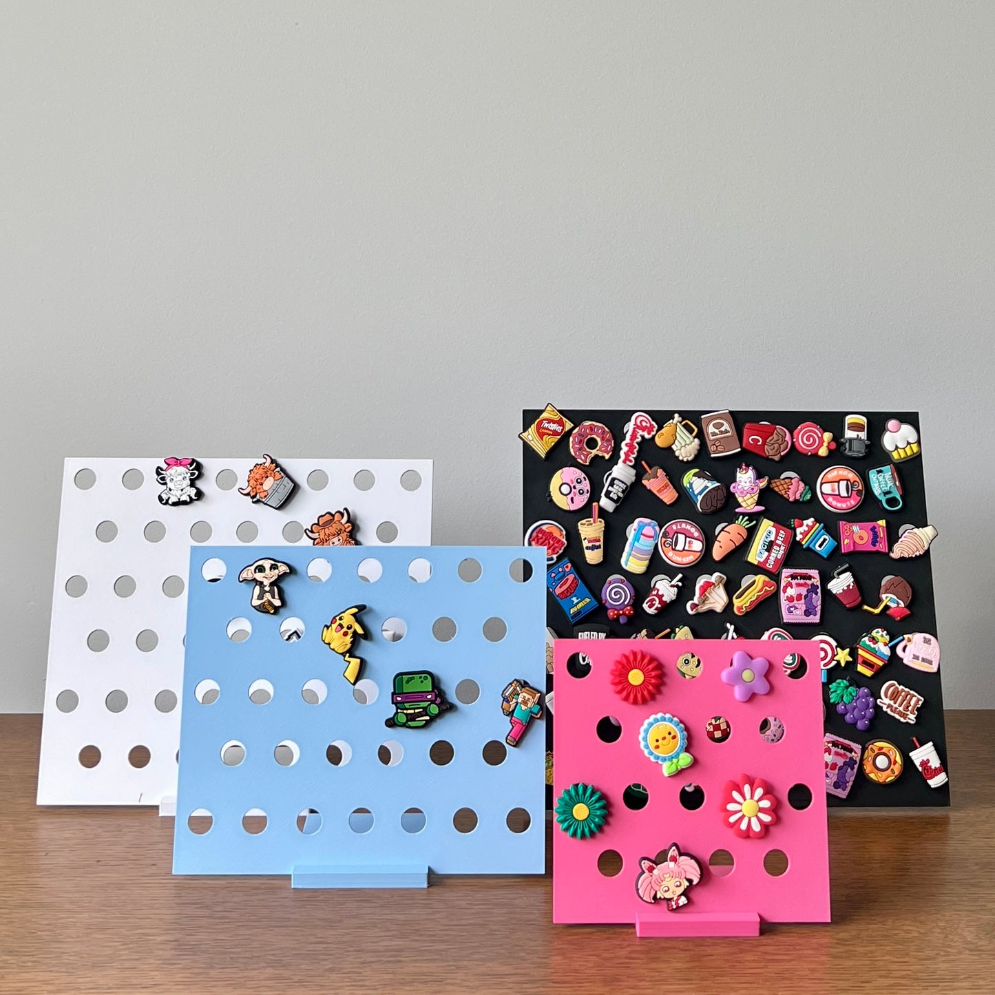 Colorful stands showcasing an array of whimsical charms against a light background, perfect for display and organization.