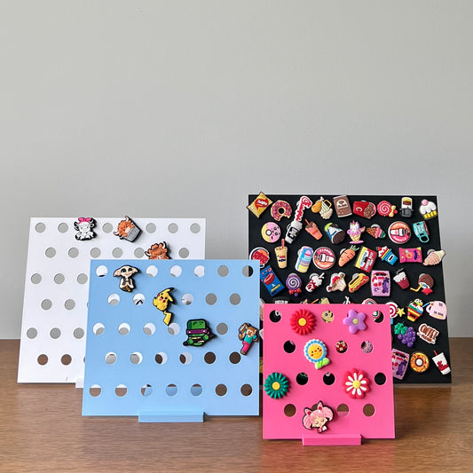 Colorful stands showcasing an array of whimsical charms against a light background, perfect for display and organization.