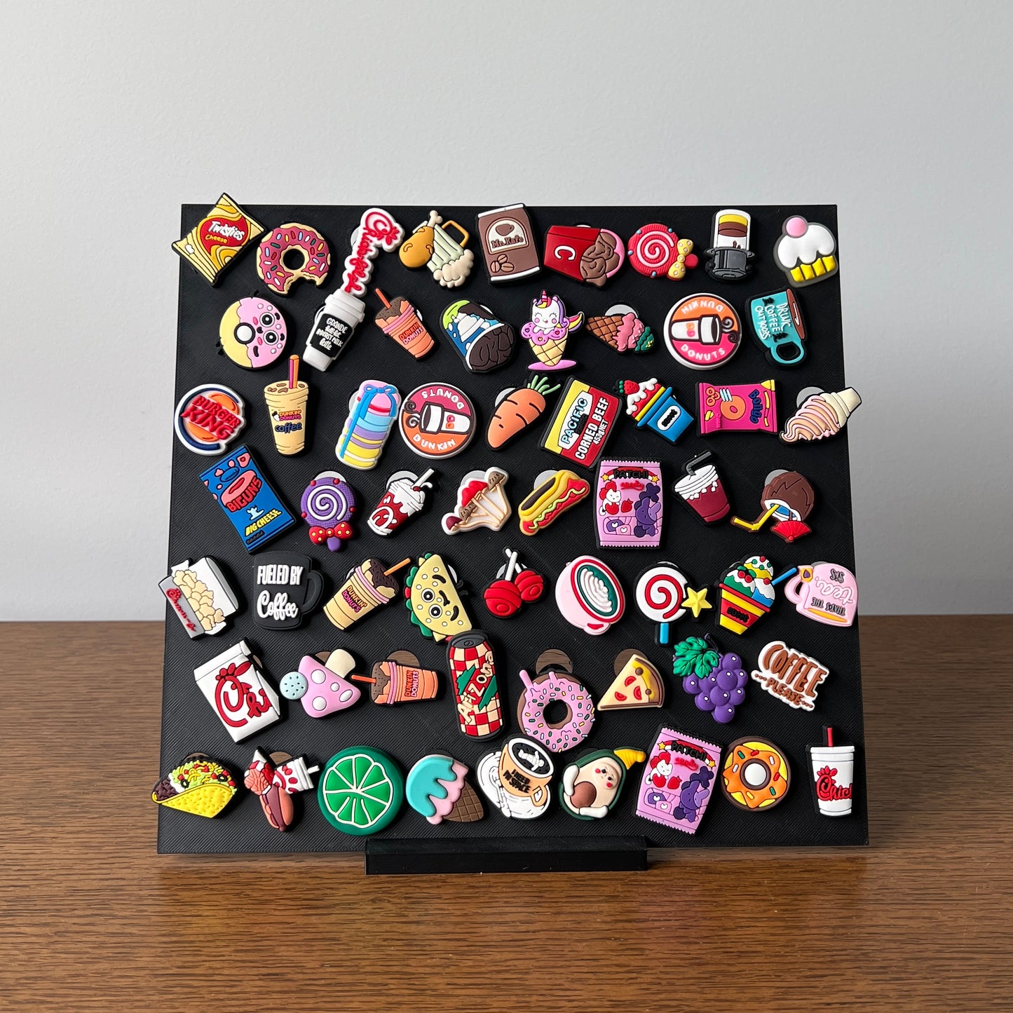 Colorful display of various charming collectibles arranged on a sleek black stand, showcasing fun, whimsical designs.