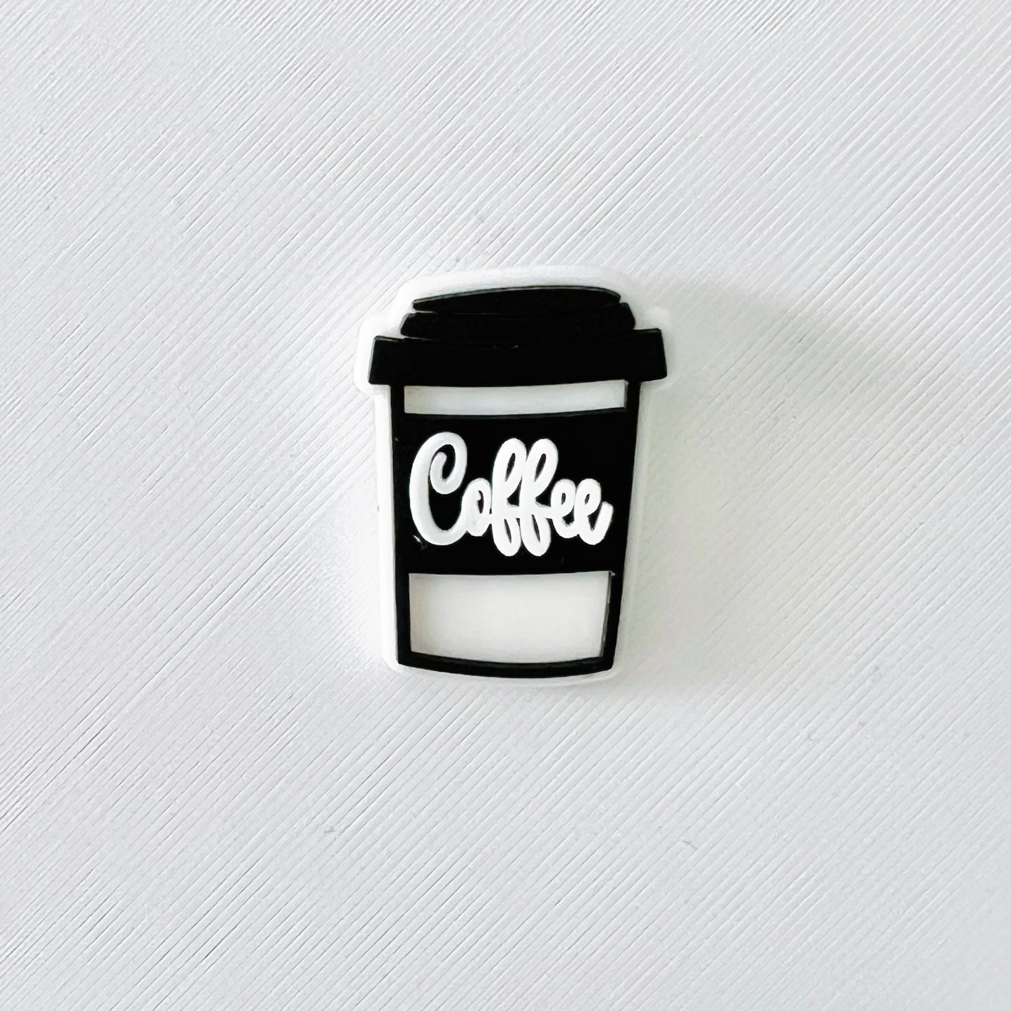 Sleek black coffee cup charm featuring "Coffee" in white, perfect for personalizing clog-style shoes.