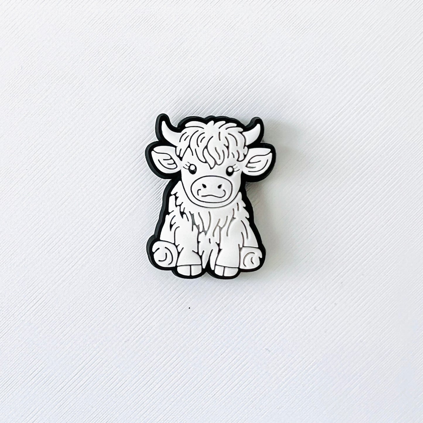 Adorable white Highland cow charm with long hair, perfect for adding flair to your shoes and delighting animal lovers.