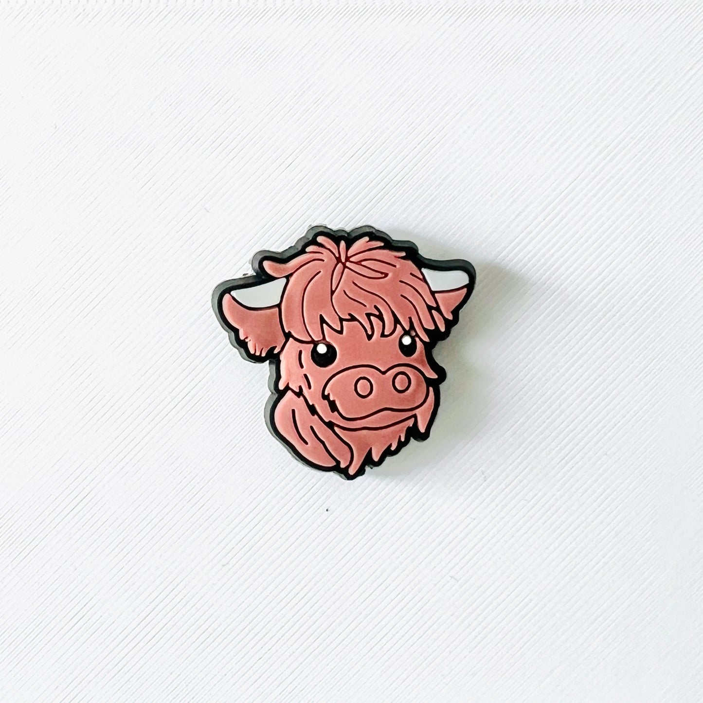 Adorable brown Highland cow face charm with fluffy fur and sweet expression, perfect for personalizing shoes.