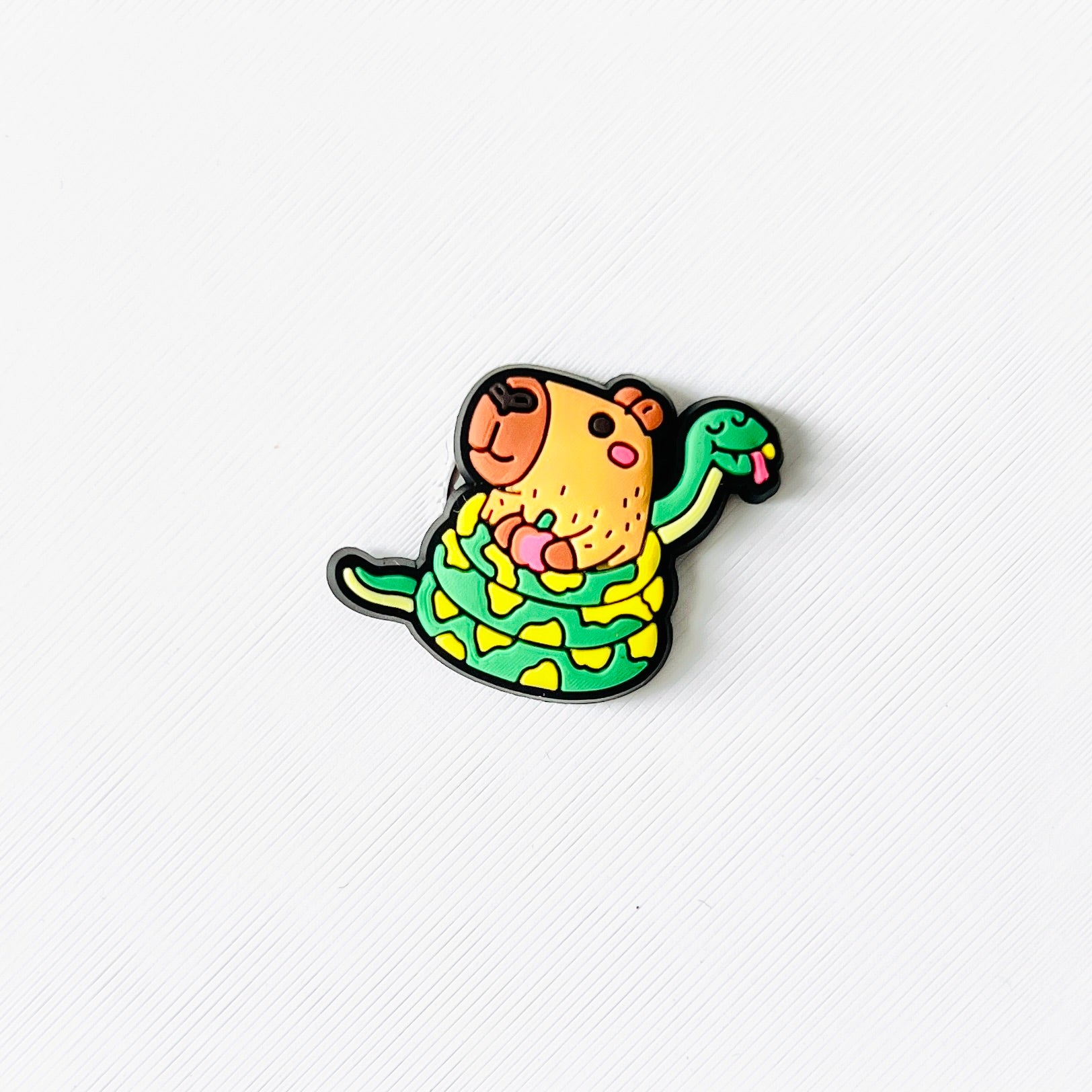A cheerful capybara wrapped in a green snake, both with playful details, perfect for animal lovers.