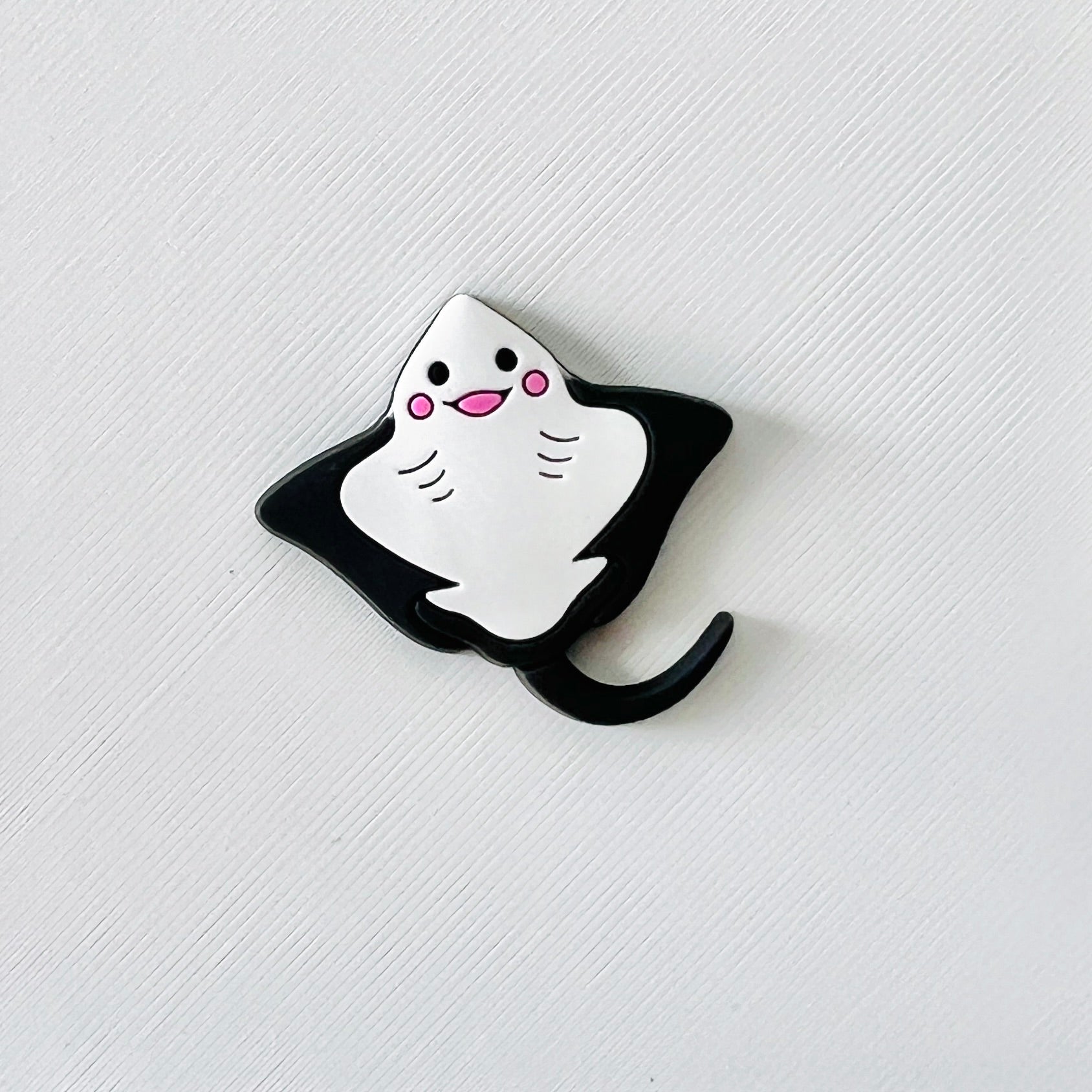 Adorable smiling stingray charm in black and white, perfect for adding a fun ocean touch to your shoes.