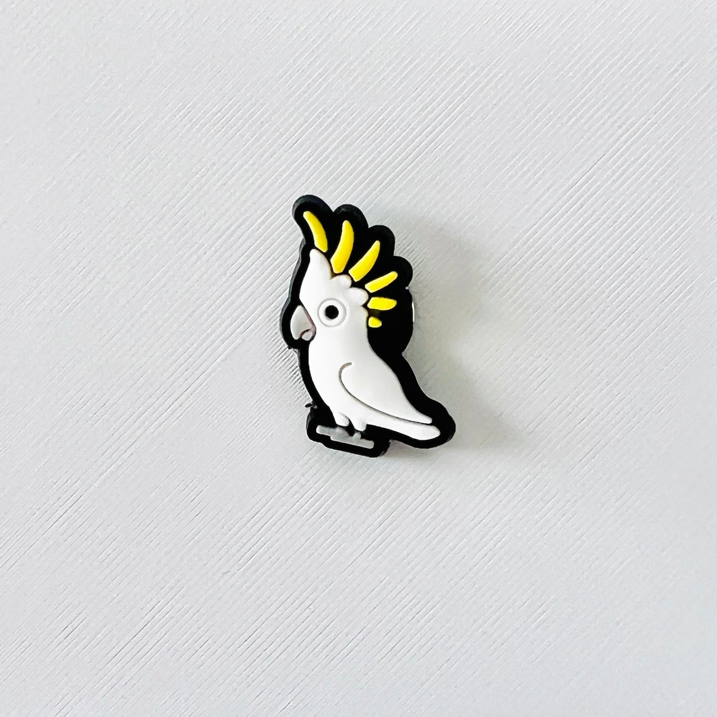 Bright sulphur-crested cockatoo charm with a playful expression and vibrant yellow crest, perfect for shoe decoration.