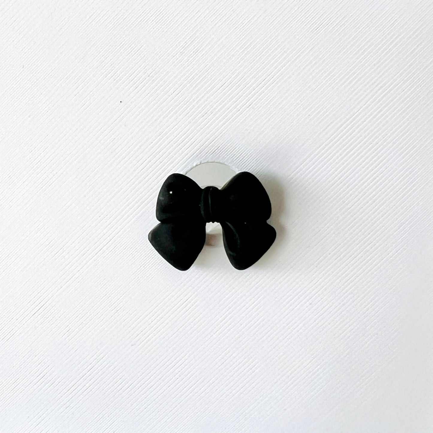 Elegant black bow charm on a white background, perfect for adding chic style to shoes. Easy to attach and remove.