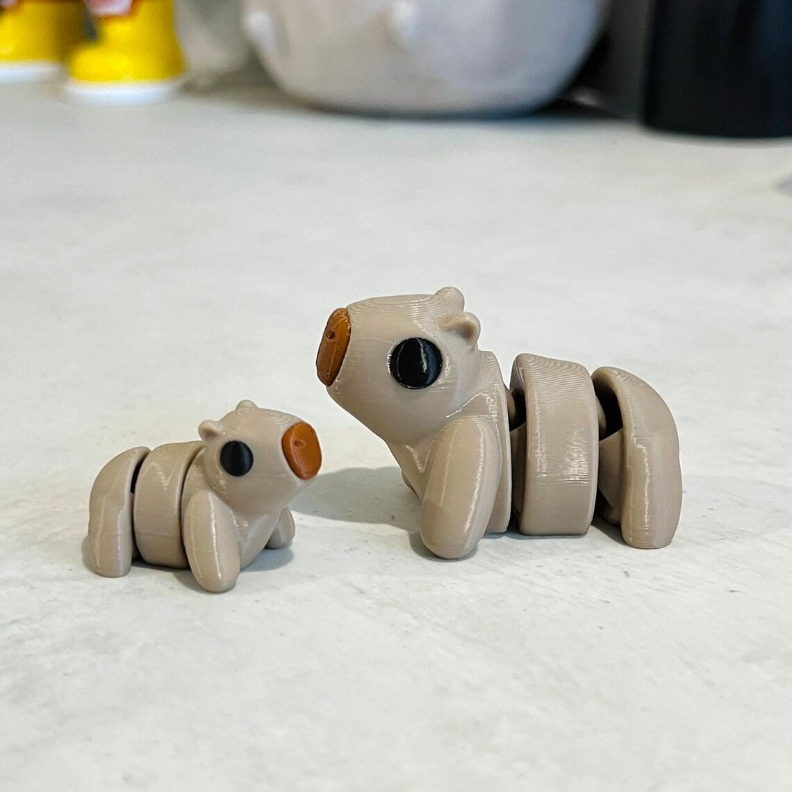 Adorable articulated capybaras in soft beige, featuring expressive eyes and a charming design, perfect for sensory play.