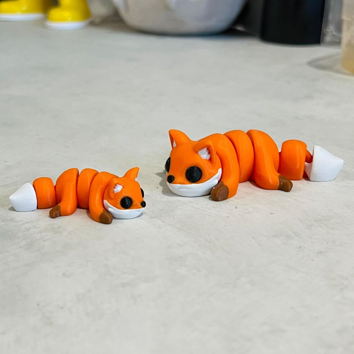 Articulated mini fox figures in vibrant orange and white, perfect for sensory play and stress relief.