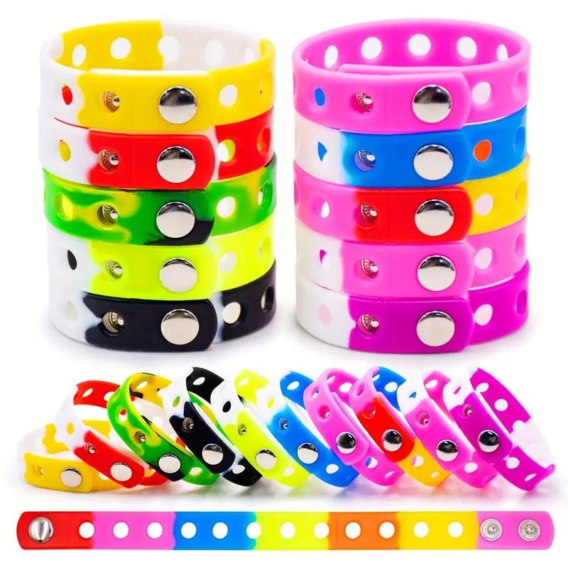 Colorful silicone wristbands in various hues, featuring holes for charms, perfect for personalizing your style.