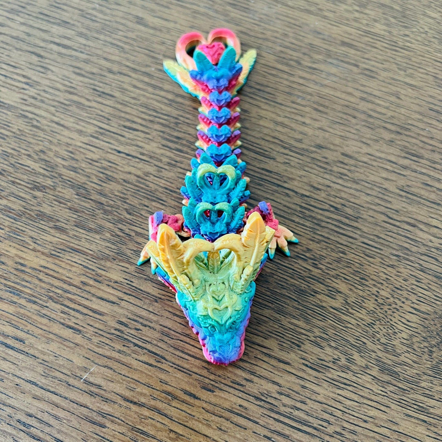 Colorful 3D printed dragon with heart shapes and intricate details, perfect for sensory play and stress relief.