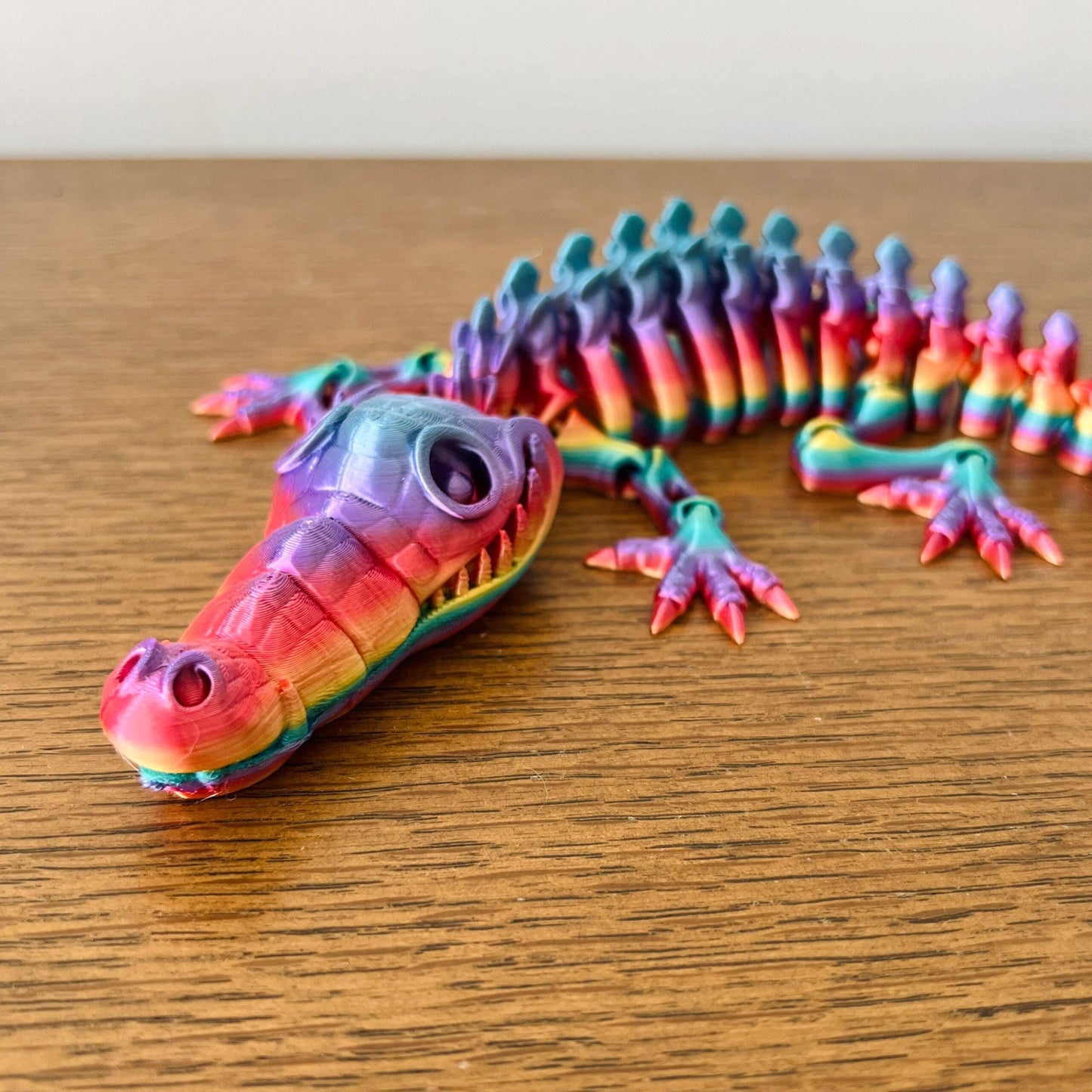 Vibrant, articulated crocodile figurine showcasing intricate details and a colorful, eye-catching design.