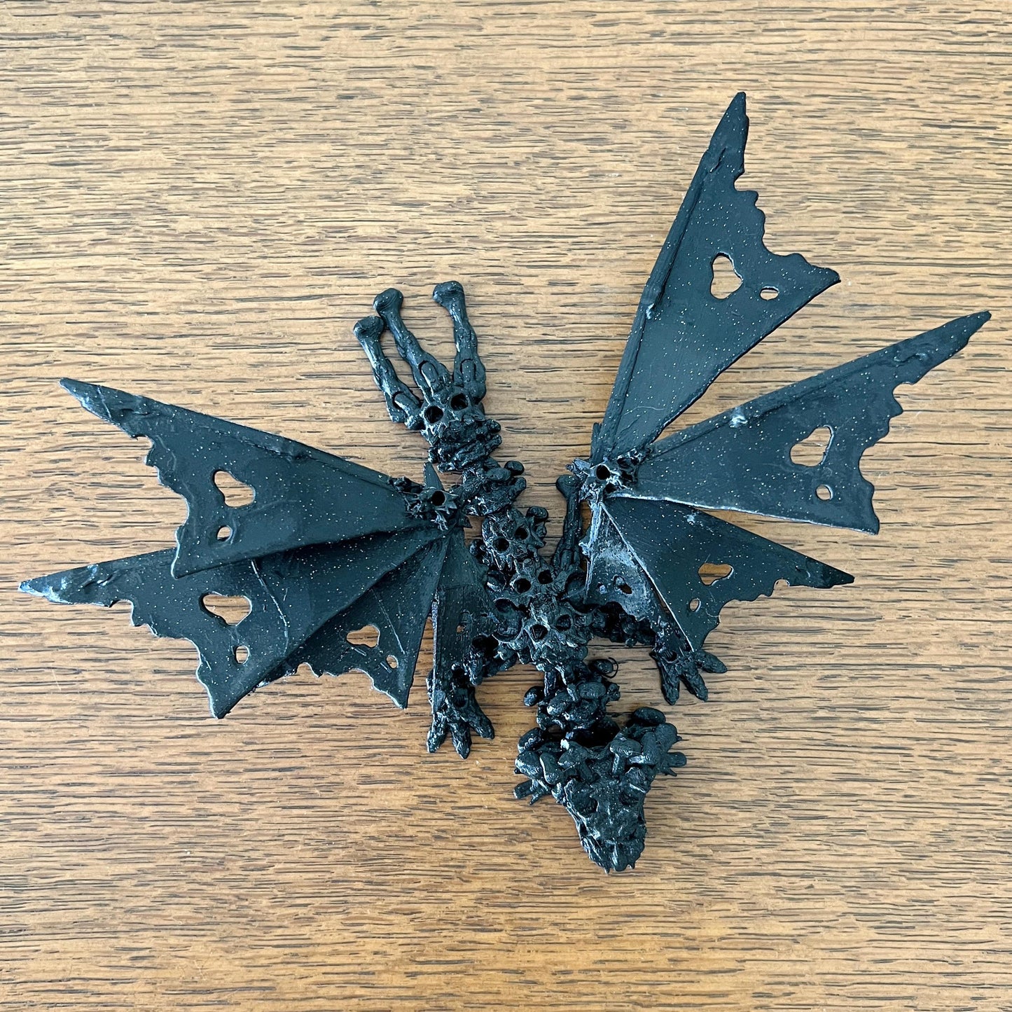 A haunting dragon with skull-like features and intricately hollow wings, exuding a mystical, edgy vibe.
