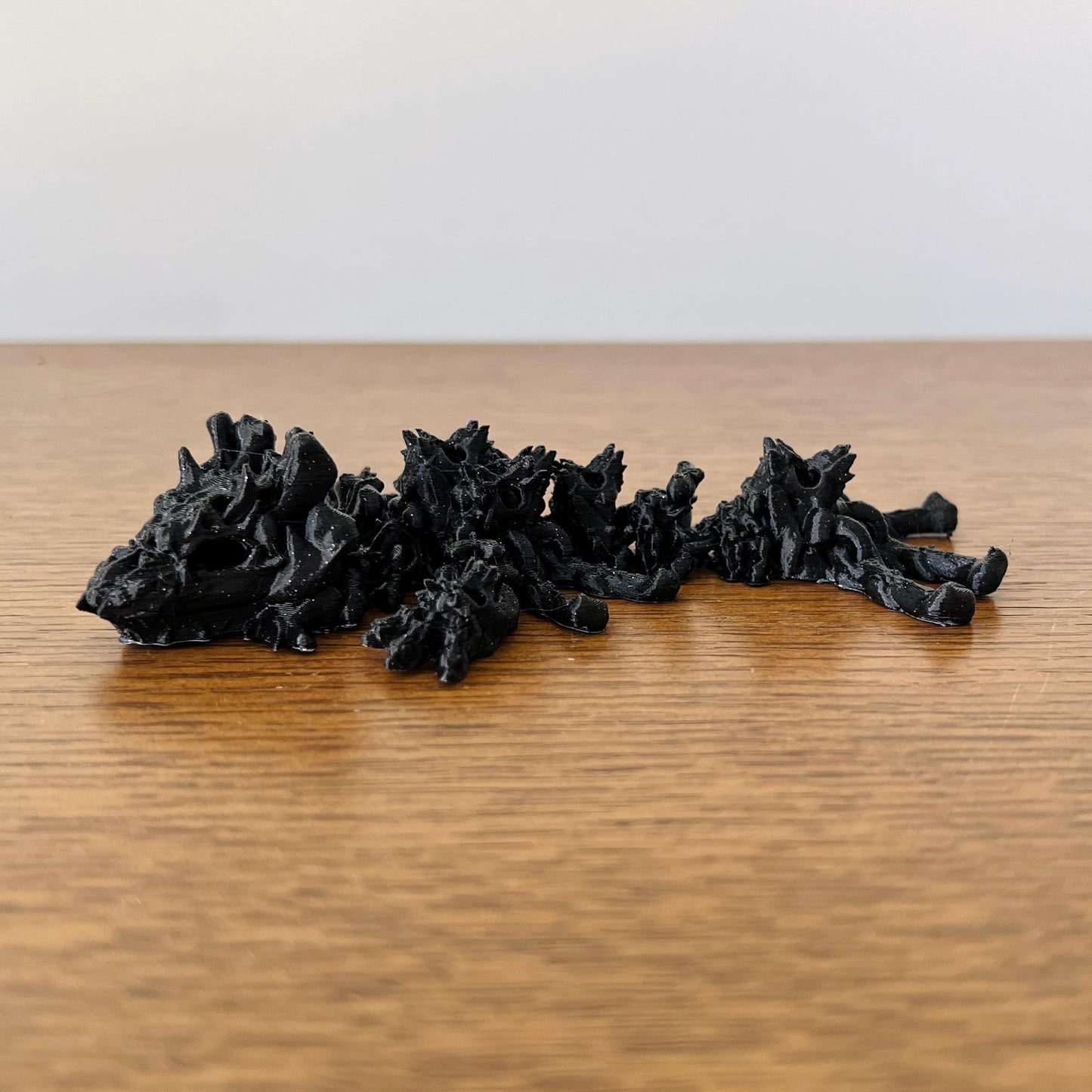 Wingless black dragon with skull-like features, adding a dark, mystical touch to any collection.