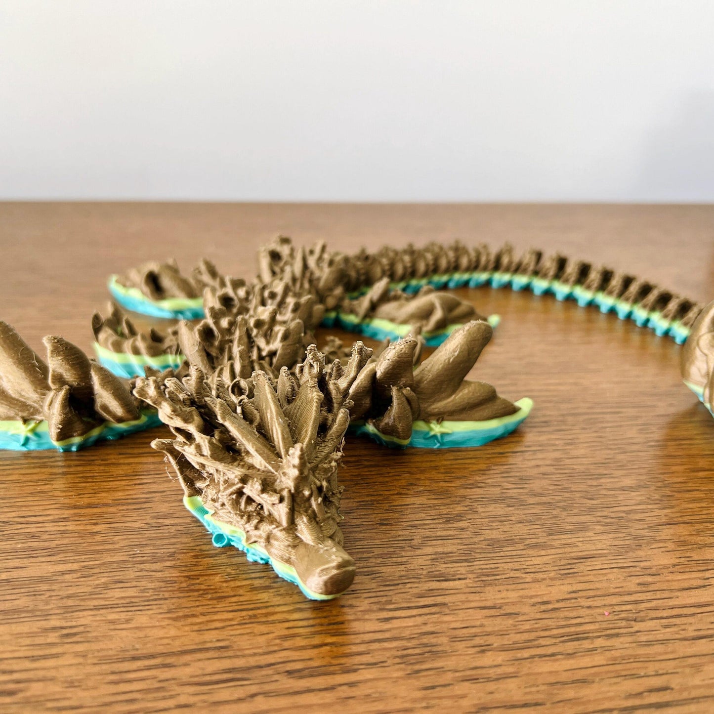 Majestic coral-inspired dragon featuring intricate details in earthy tones with vibrant oceanic hues, perfect for collectors.