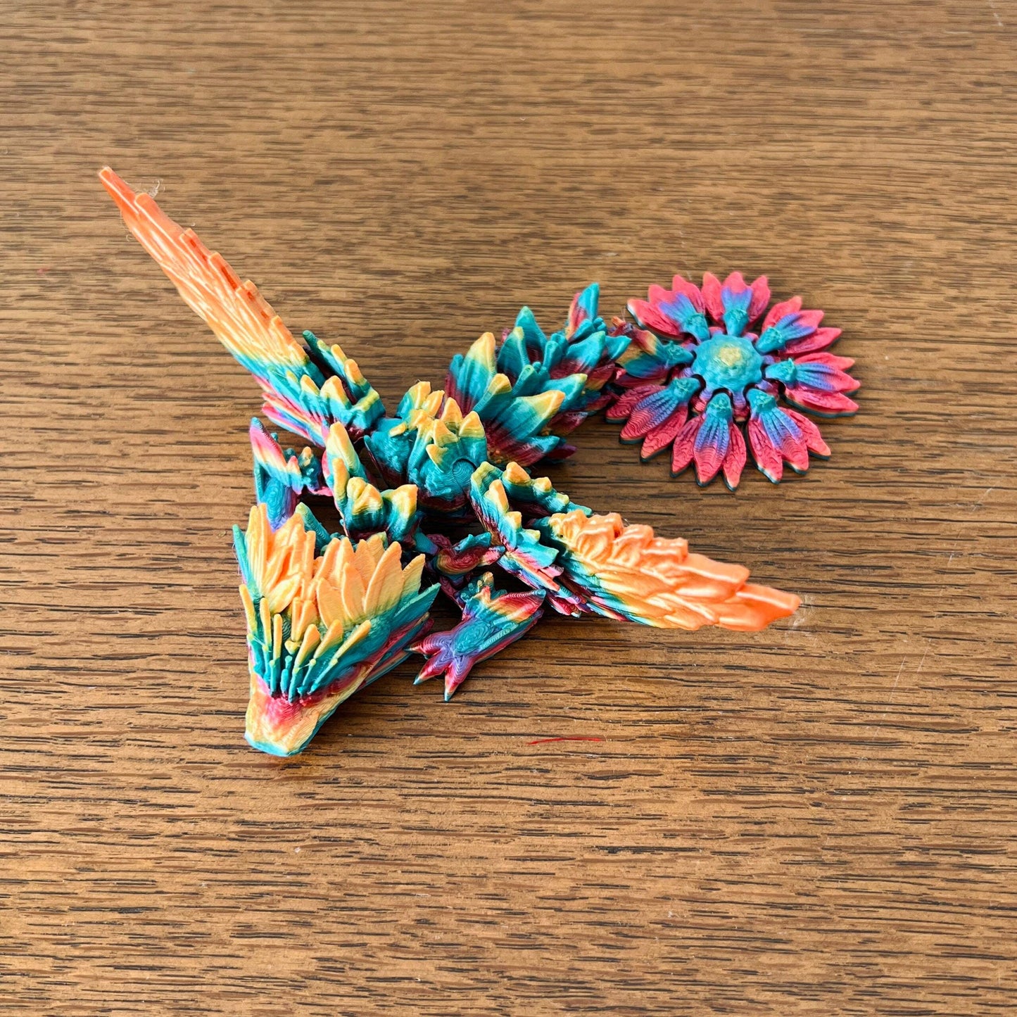 Colorful dragon with intricate sunflower-inspired wings and floral accents, showcasing vibrant details and charm.