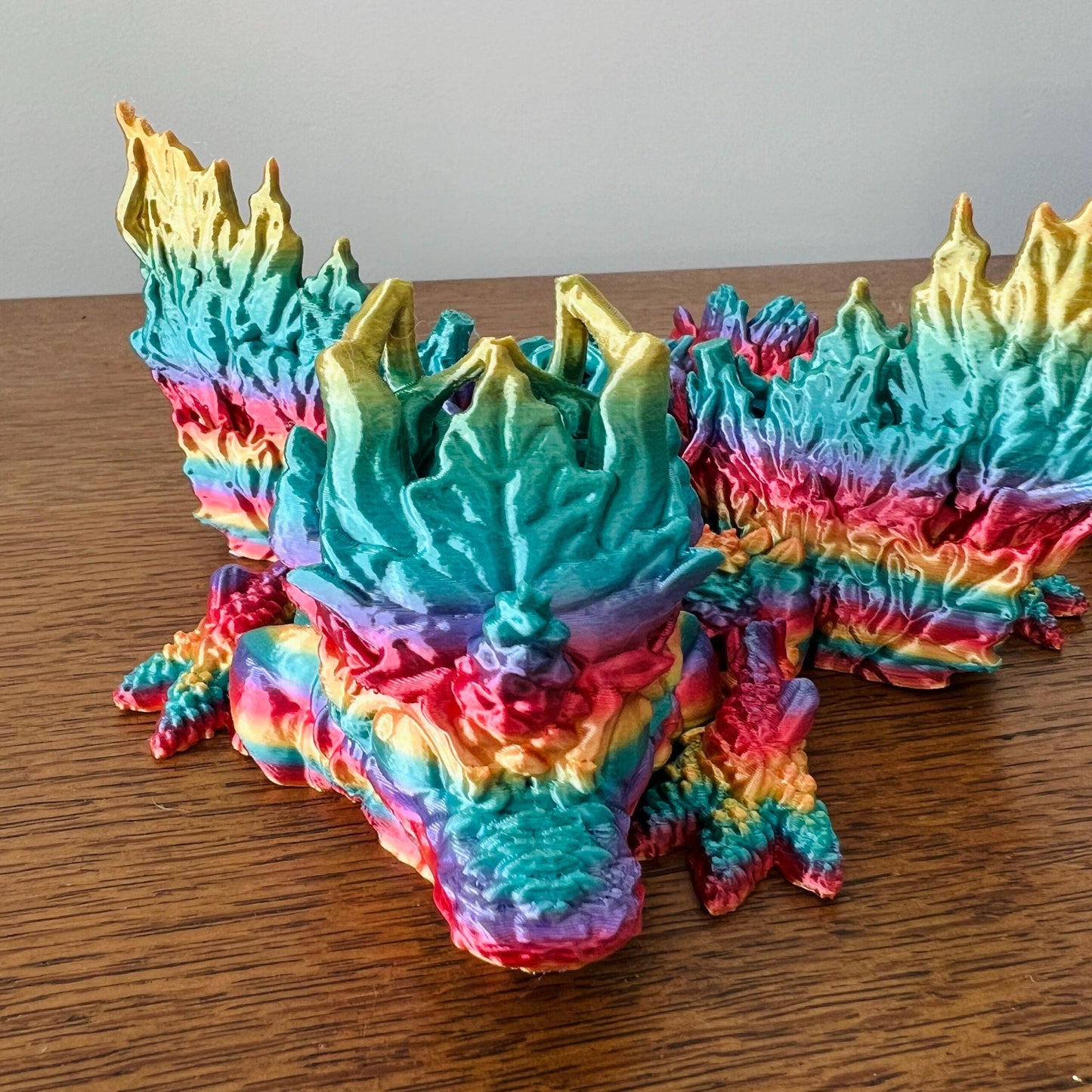 Colorful dragon with intricate wings and textures inspired by autumn leaves, showcasing vibrant fall hues.
