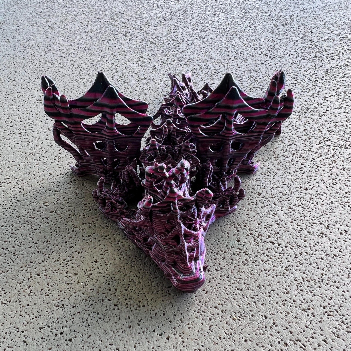 A striking dragon sculpture with intricate wings in dark hues, exuding an aura of mystery and enchantment.