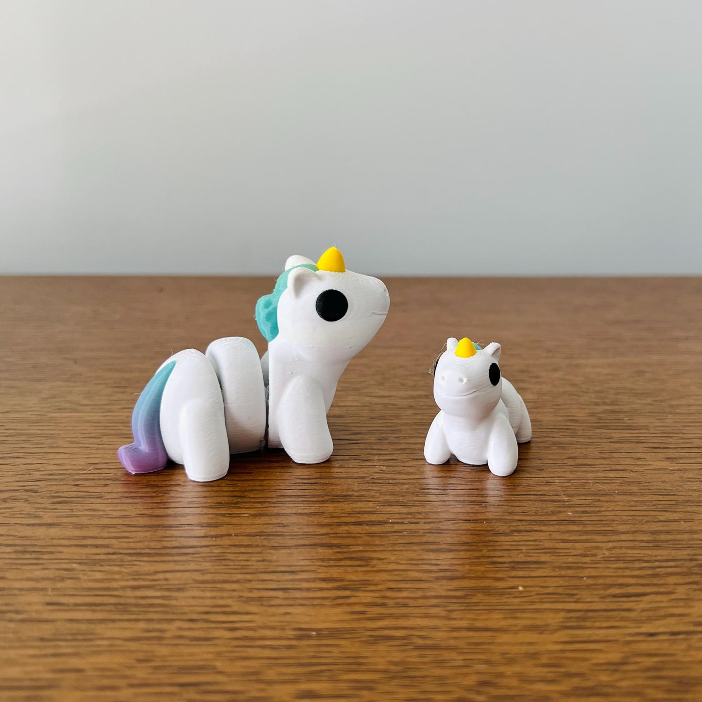 Mini Rainbow Unicorns with a playful white body and vibrant rainbow mane, perfect for sensory play and stress relief.