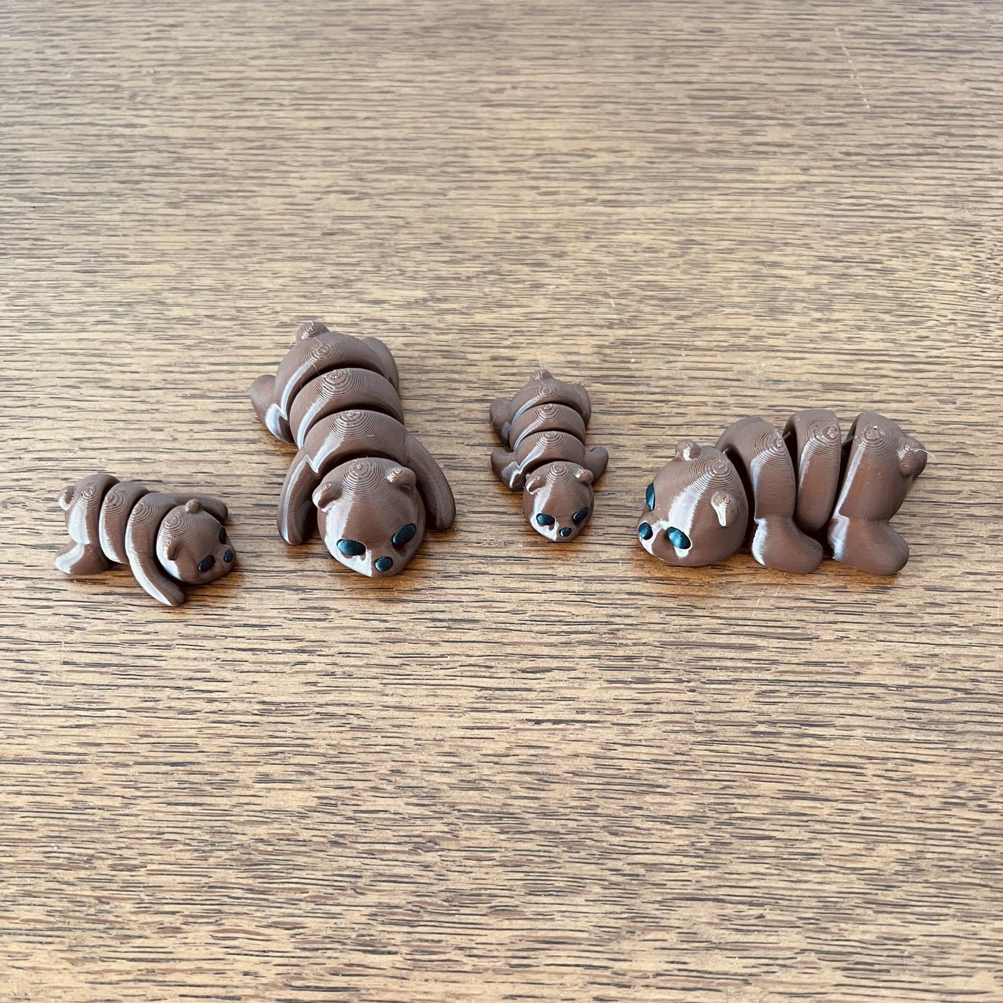 Adorable Mini Brown Bears in various poses, showcasing a cute, playful design with big eyes and a soft brown finish.