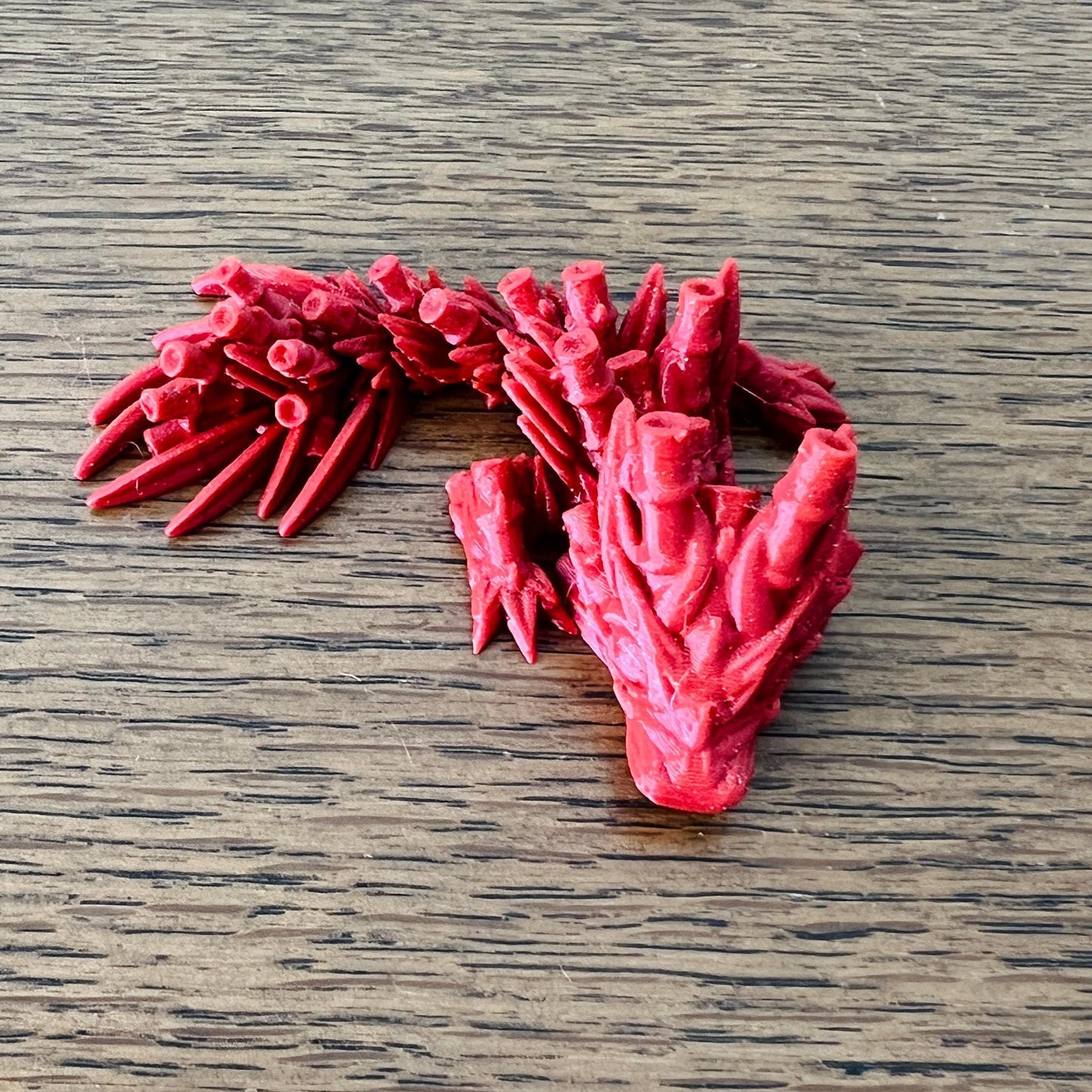 Mini Bamboo Dragon in vibrant red, featuring intricate bamboo-inspired details and a serene, whimsical posture.
