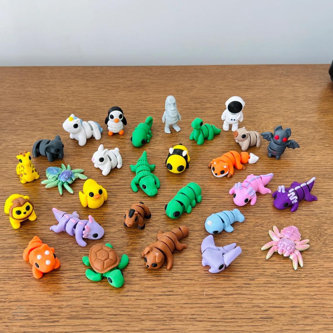 Colorful micro-sized fidget toys featuring animals and food, arranged on a wooden surface, showcasing various unique designs.