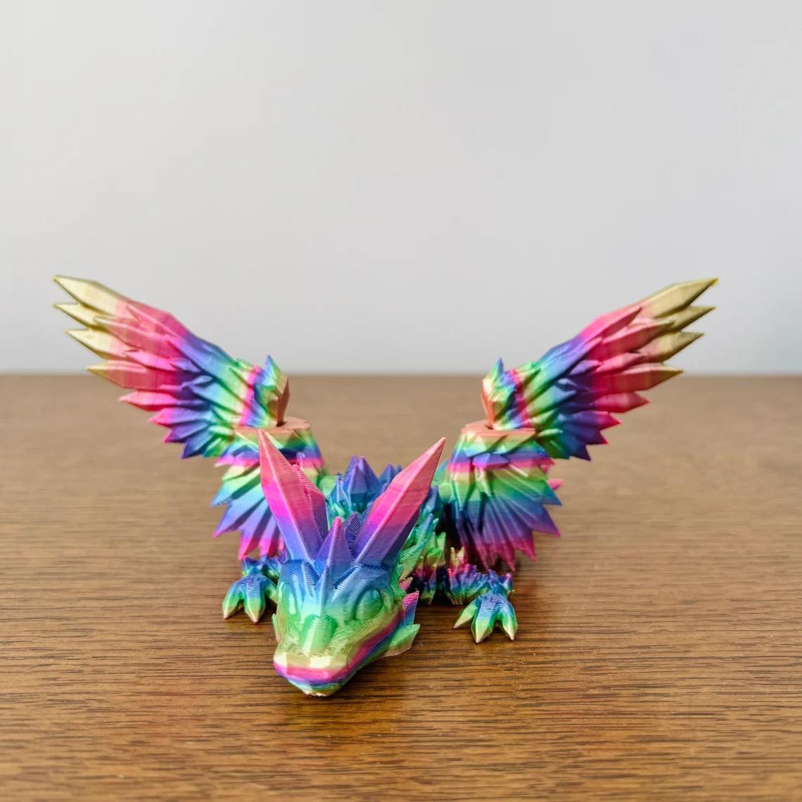 Vibrant rainbow-colored dragon with crystal-like wings, showcasing intricate details and a playful stance on a wooden surface