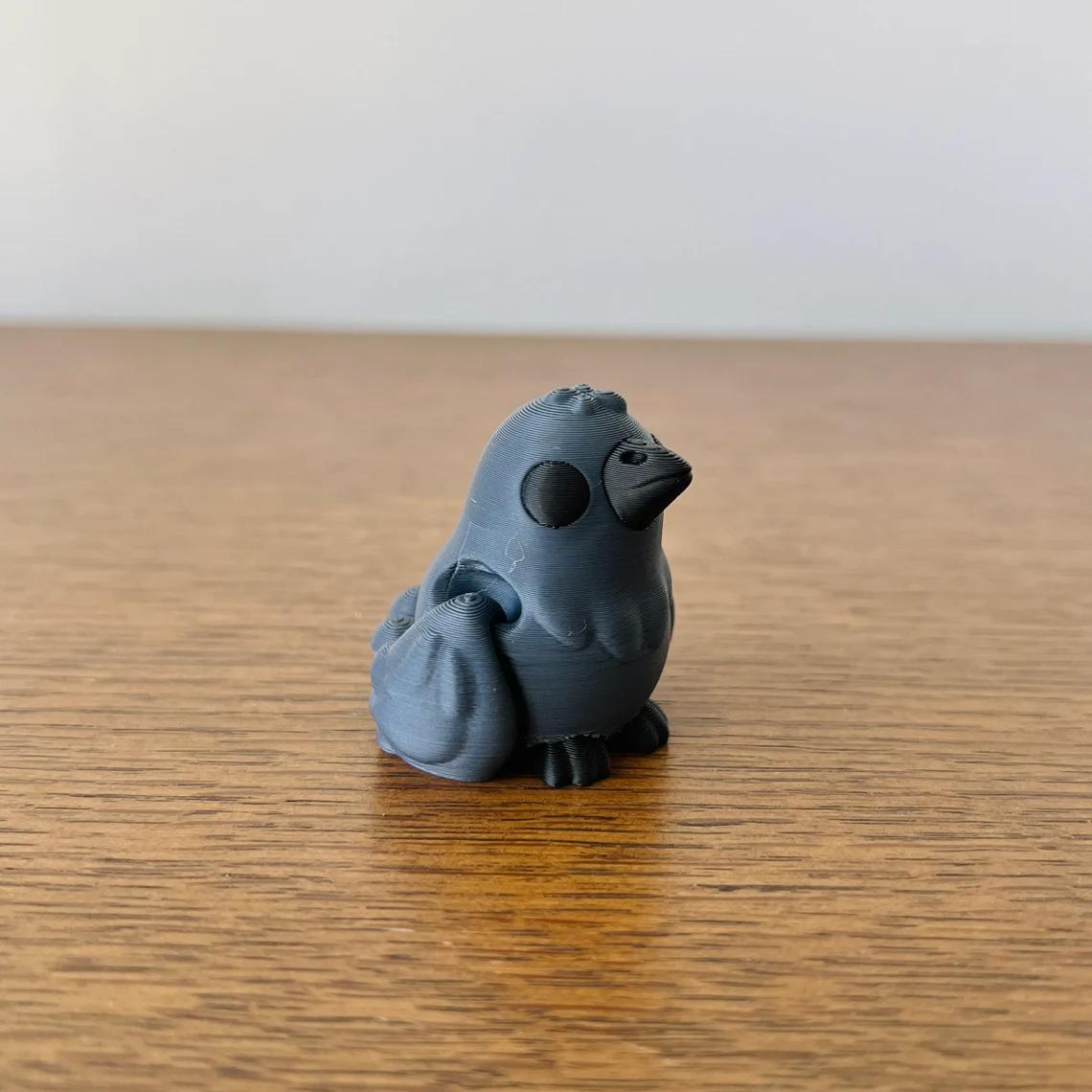 Articulated black crow figure with smooth curves, perfect for sensory play or as a unique gothic collectible.