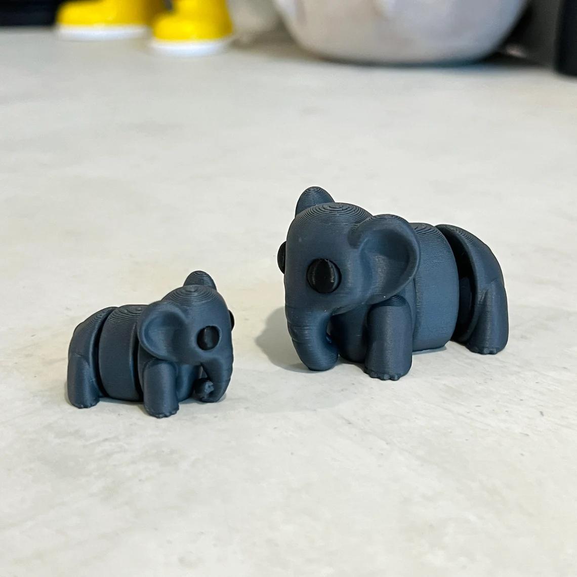 Articulated dark grey elephants in two sizes, showcasing detail and playful charm for sensory engagement and collection.