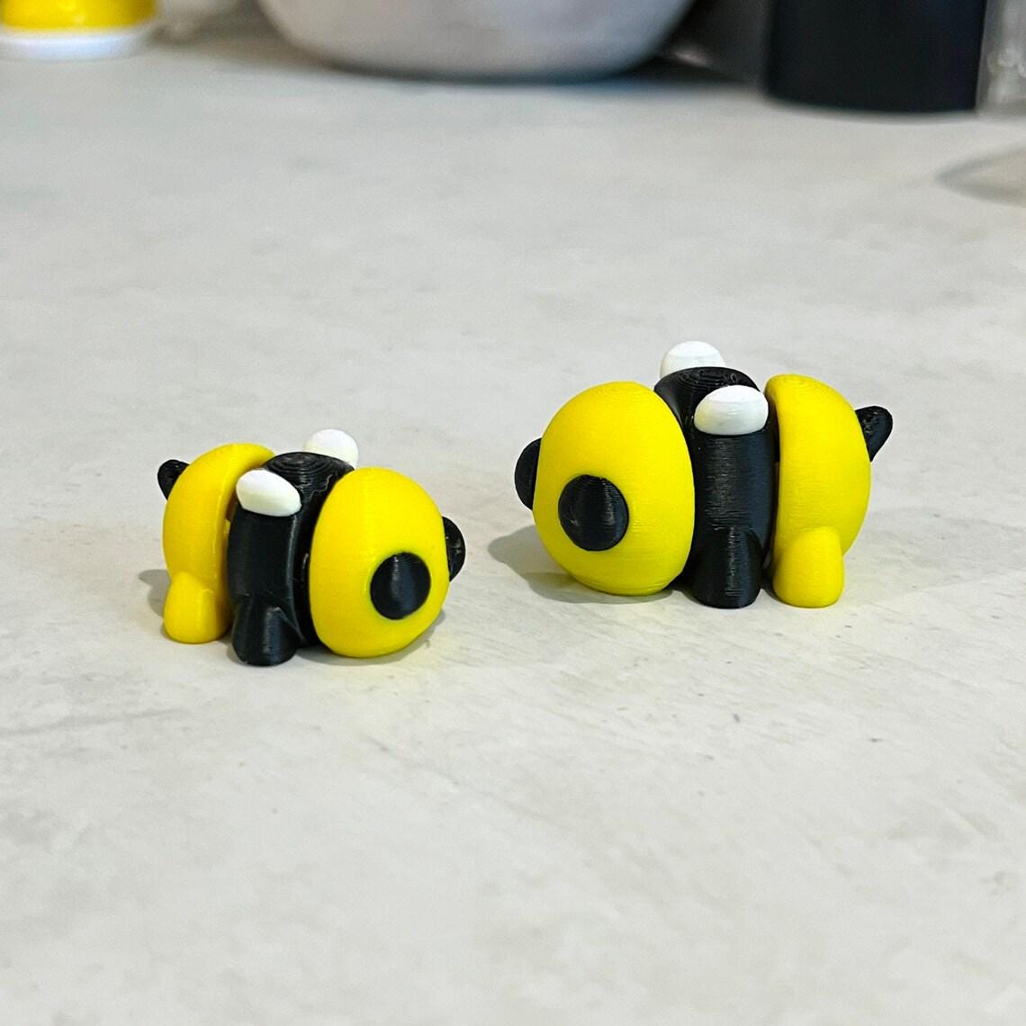 A whimsical 3D printed bumble bee in vibrant yellow and black, perfect for sensory play and stress relief.
