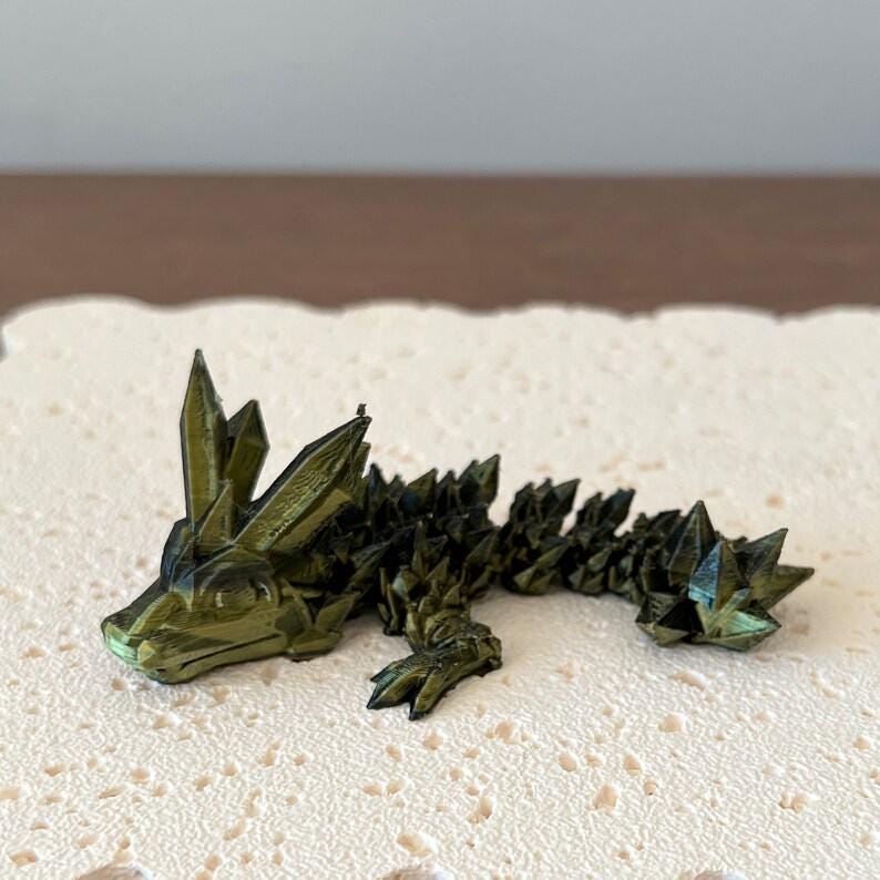 Articulated crystal dragon with vibrant green hues and intricate detailing, perfect for fantasy enthusiasts and collectors.