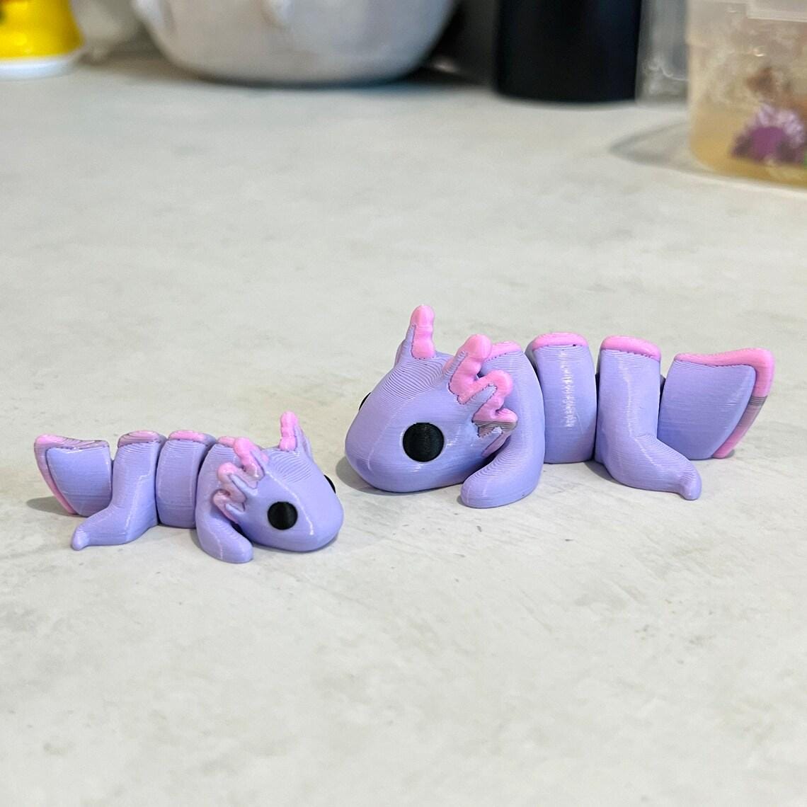 Pastel purple axolotls with pink accents, showcasing articulated bodies, perfect for sensory play and relaxation.