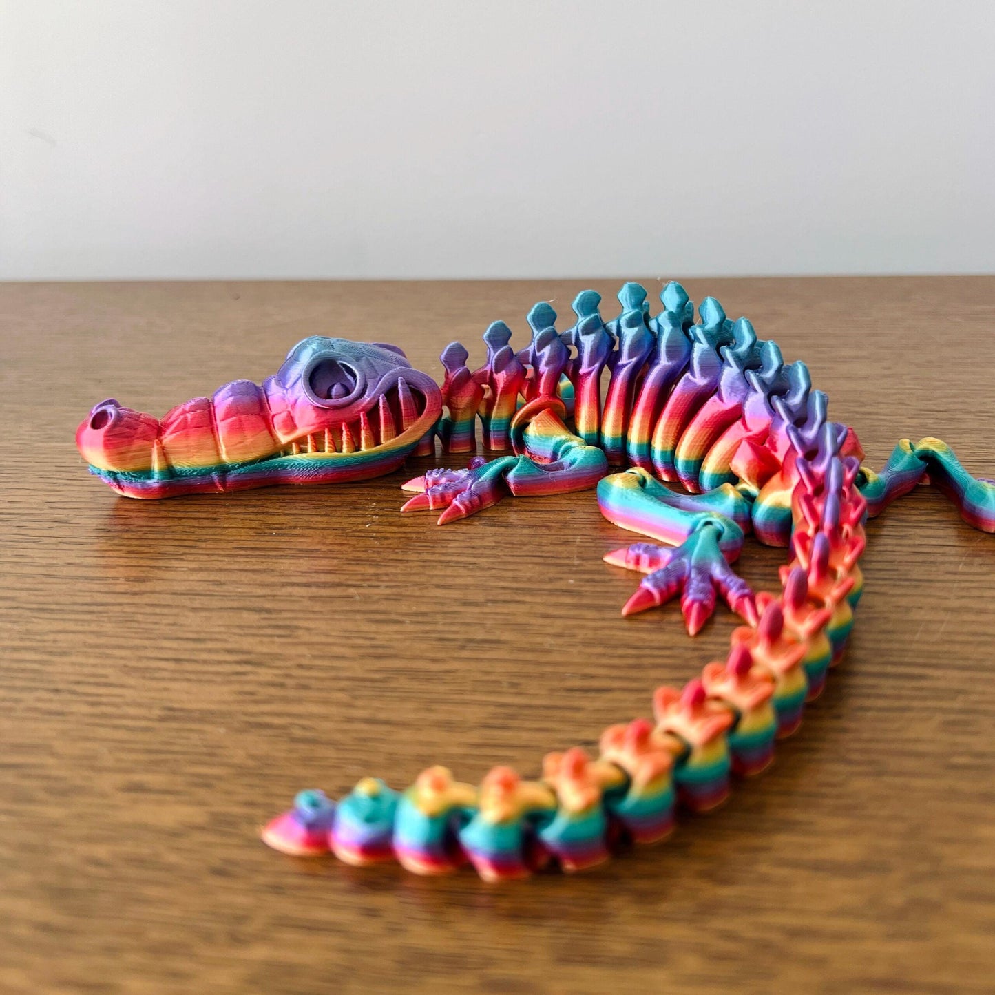 Vibrant articulated crocodile figurine showcasing detailed features and a rainbow color palette, perfect for collectors.
