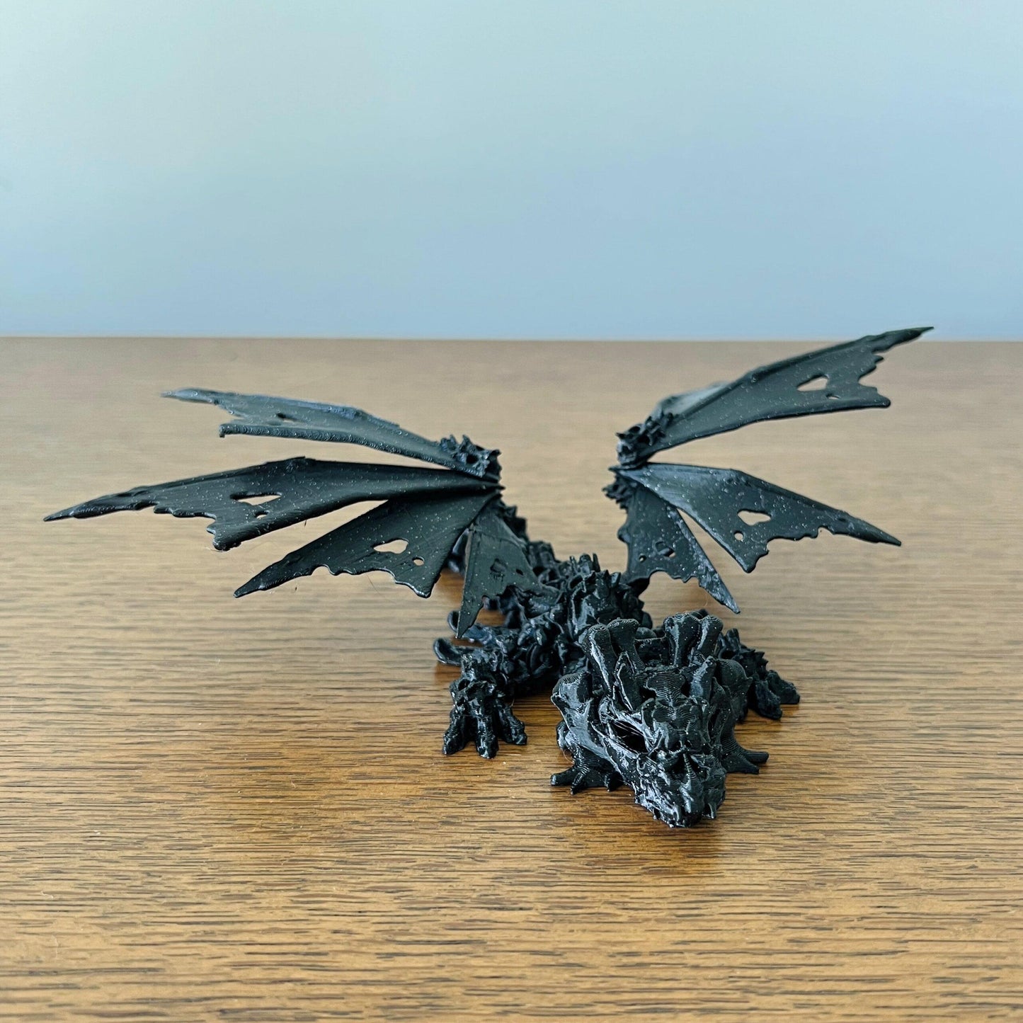 A haunting dragon with skull-like features and intricate hollow wings, exuding an edgy, mystical vibe.