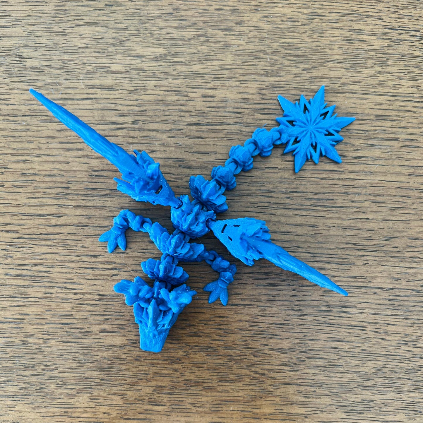 Frosty blue dragon with intricate icy wings and snowy accents, embodying the magic of winter's beauty.