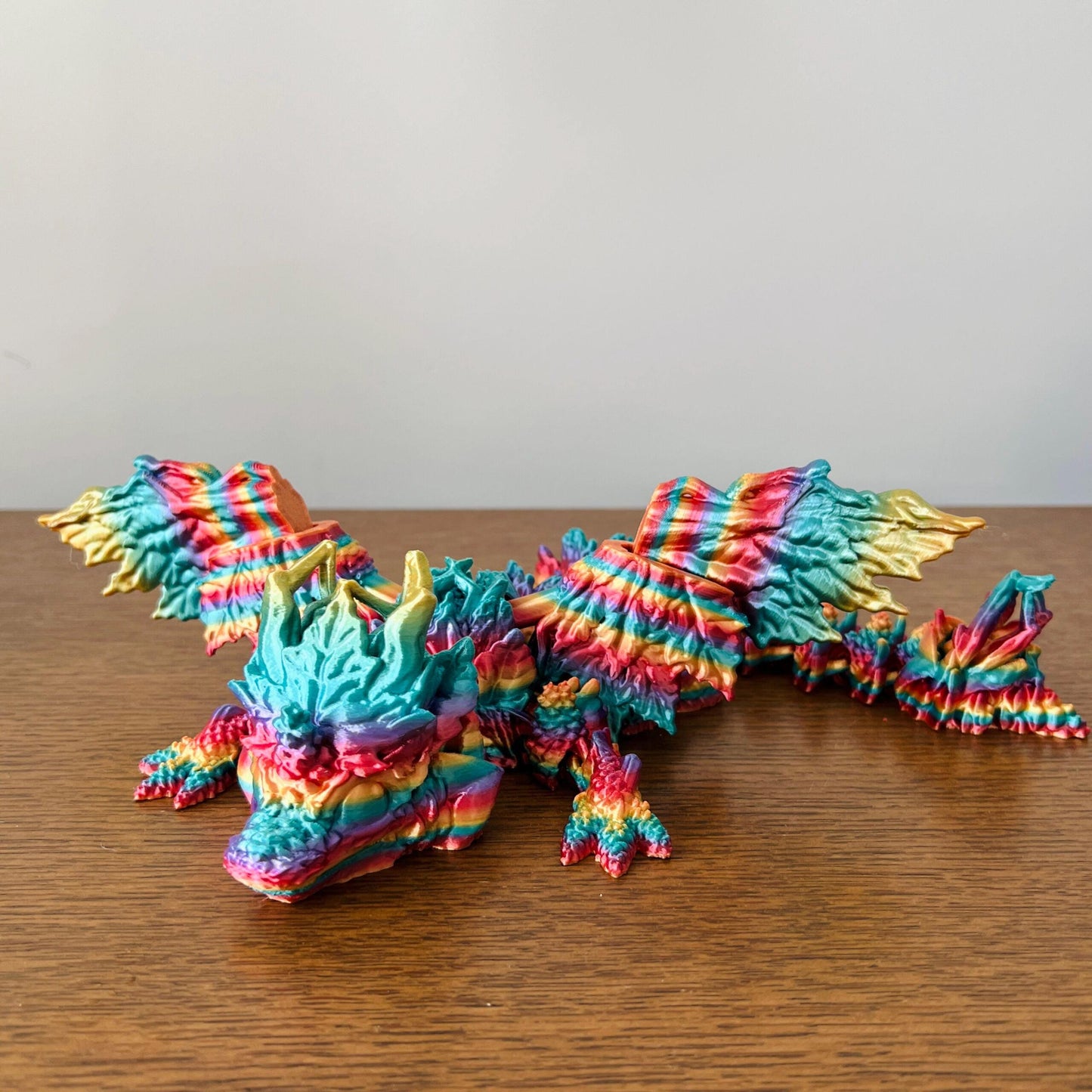 Colorful winged dragon with intricate textures, showcasing vibrant autumn hues and elegant detailing.