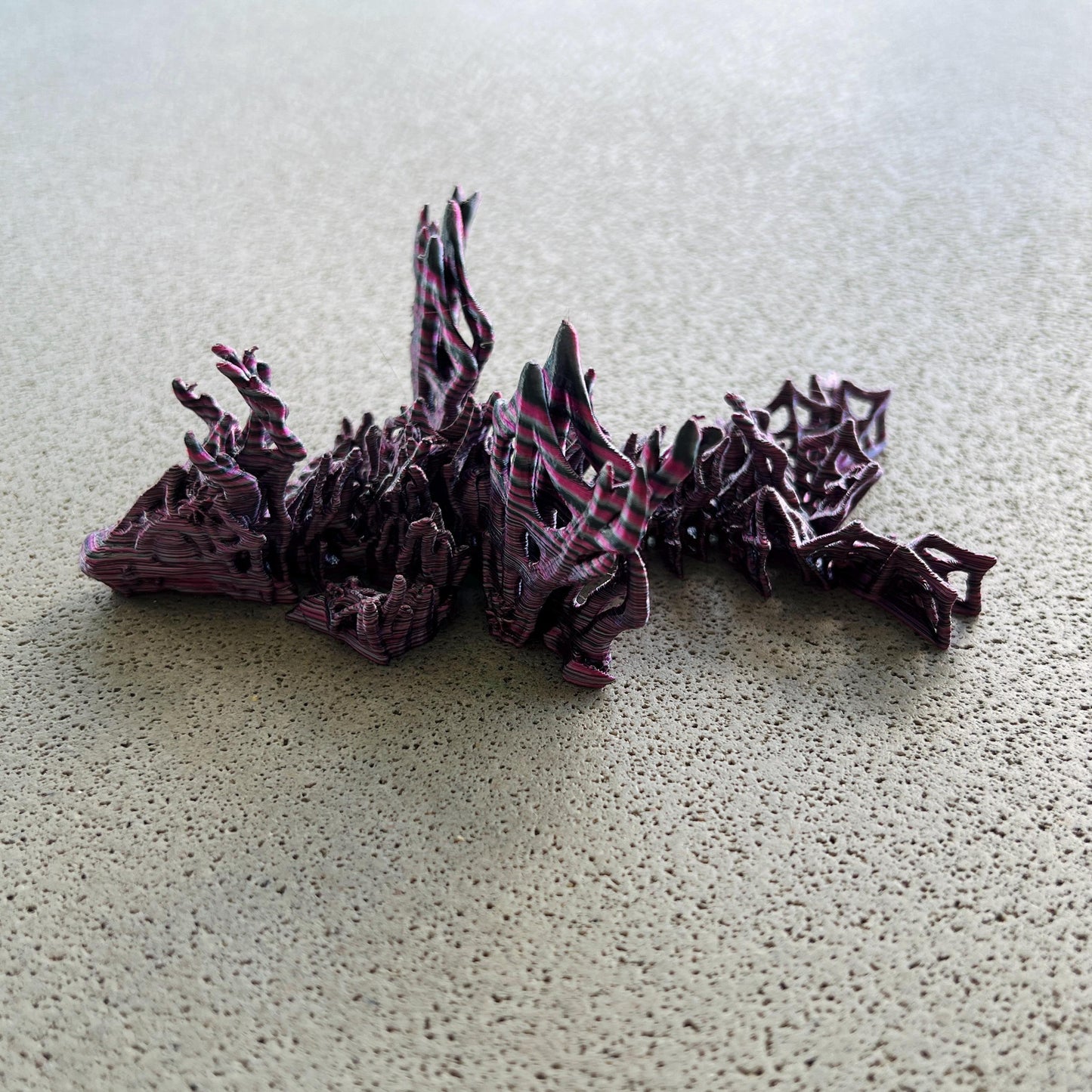 A wicked dragon with intricate wings and a dark, mysterious design, perfect for enchanting any collection.