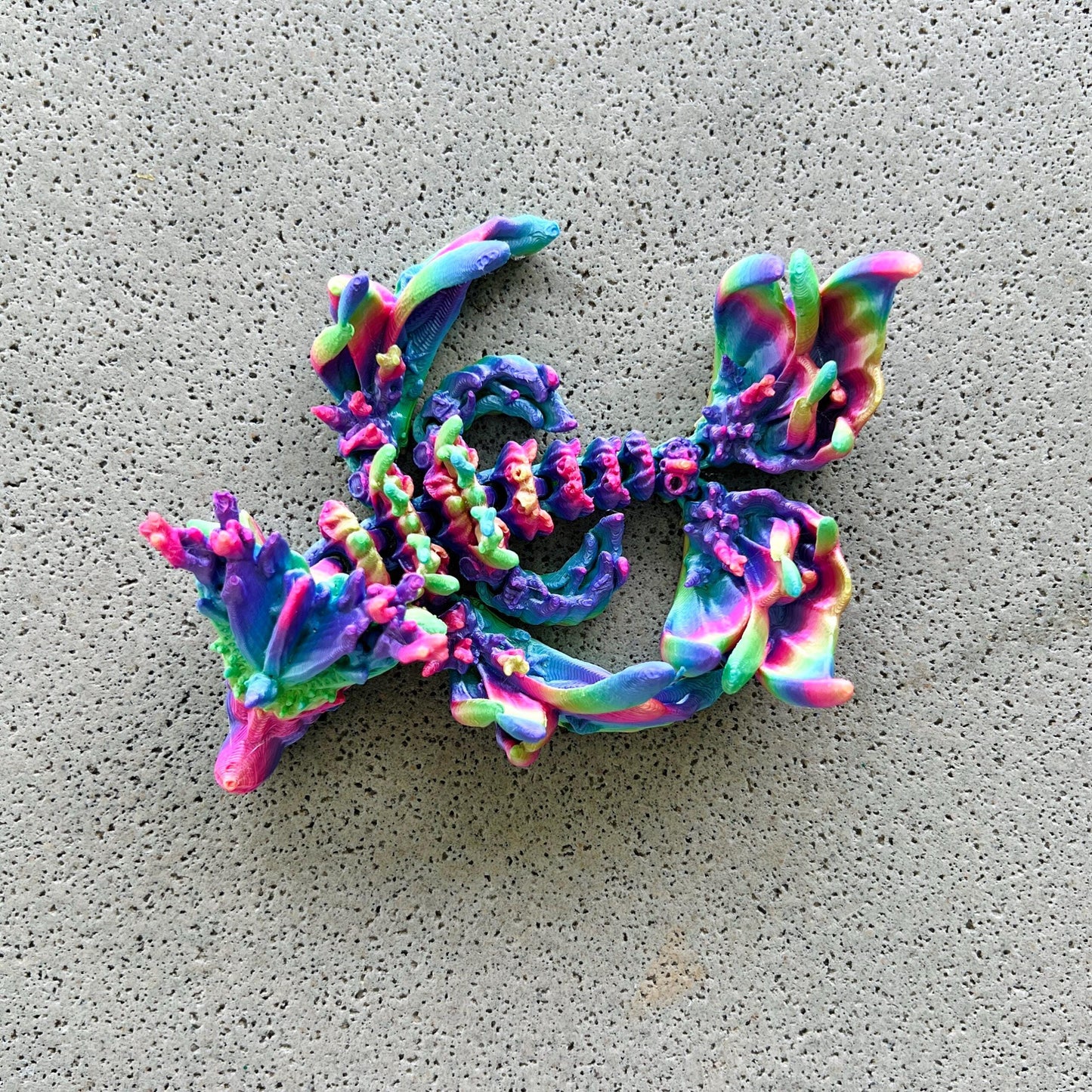 Colorful winged dragon with intricate coral-like details, showcasing vibrant oceanic hues and a whimsical marine theme.