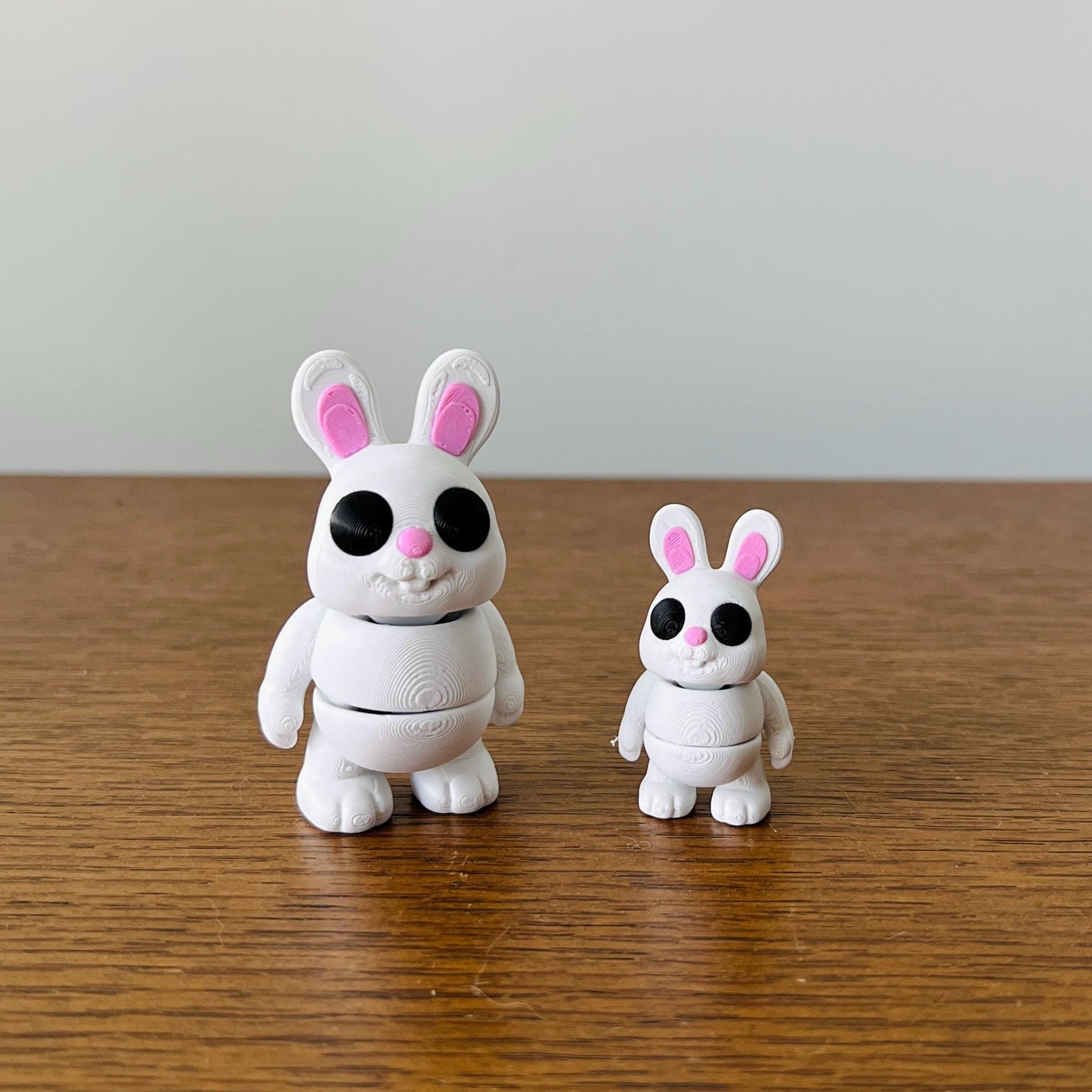 Charming white bunny rabbits with pink noses and ears, perfect for sensory play and stress relief.