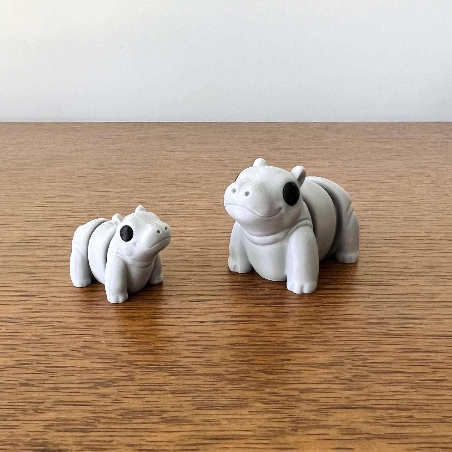 Charming mini hippos in soft gray, featuring expressive faces and articulated bodies for engaging tactile fun.