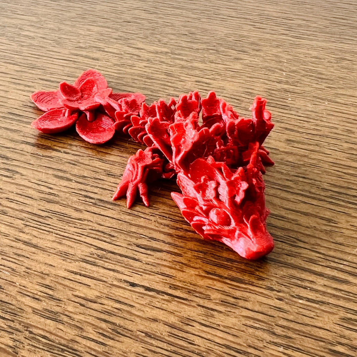 Delicate red dragon intertwined with cherry blossoms, showcasing intricate details and vibrant spring inspiration.