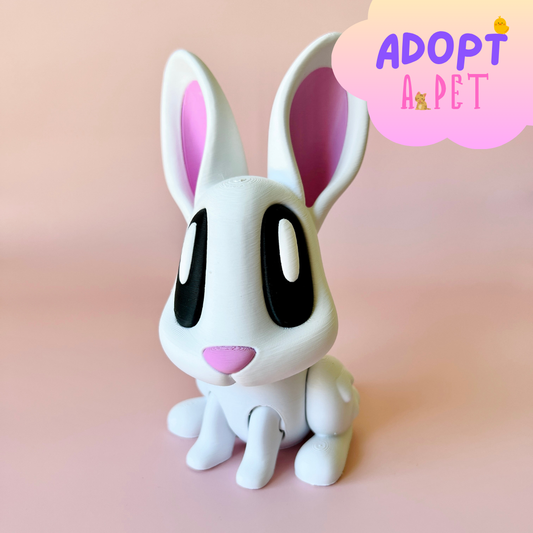 A white rabbit figure with large black eyes and pink accents, set against a soft pink background.