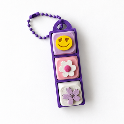 3 Key Fidget Clicker, 3D printed fidget clicker in purple with smiley, daisy and blossom keycaps