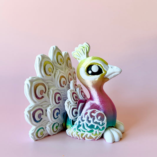 Colorful peacock figurine with intricate feather patterns, set against a soft pink background.