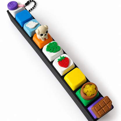 9 Key Fidget Clicker, 3D printed fidget clicker in black with colourful character keycaps, angled view