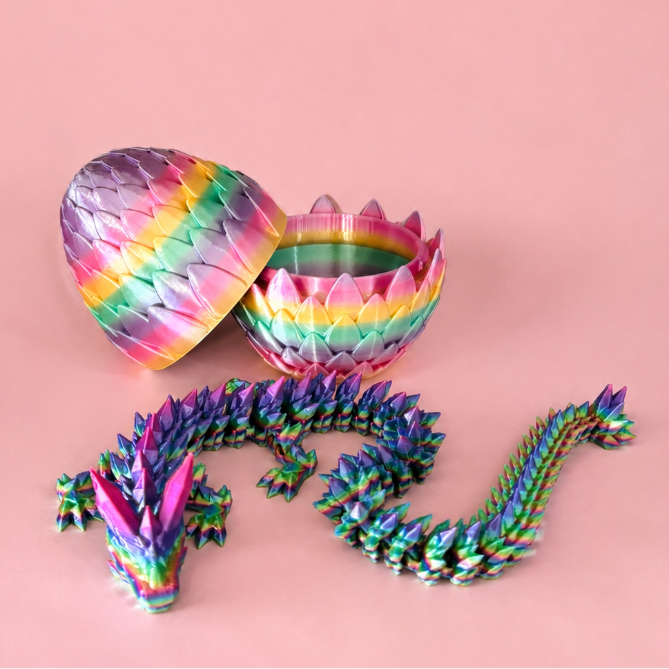 Colorful dragon-shaped toy with open shell on a pink background