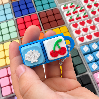 2 Key Fidget Clicker, 3D printed fidget clicker in blue with shell and cherry keycaps, held in hand
