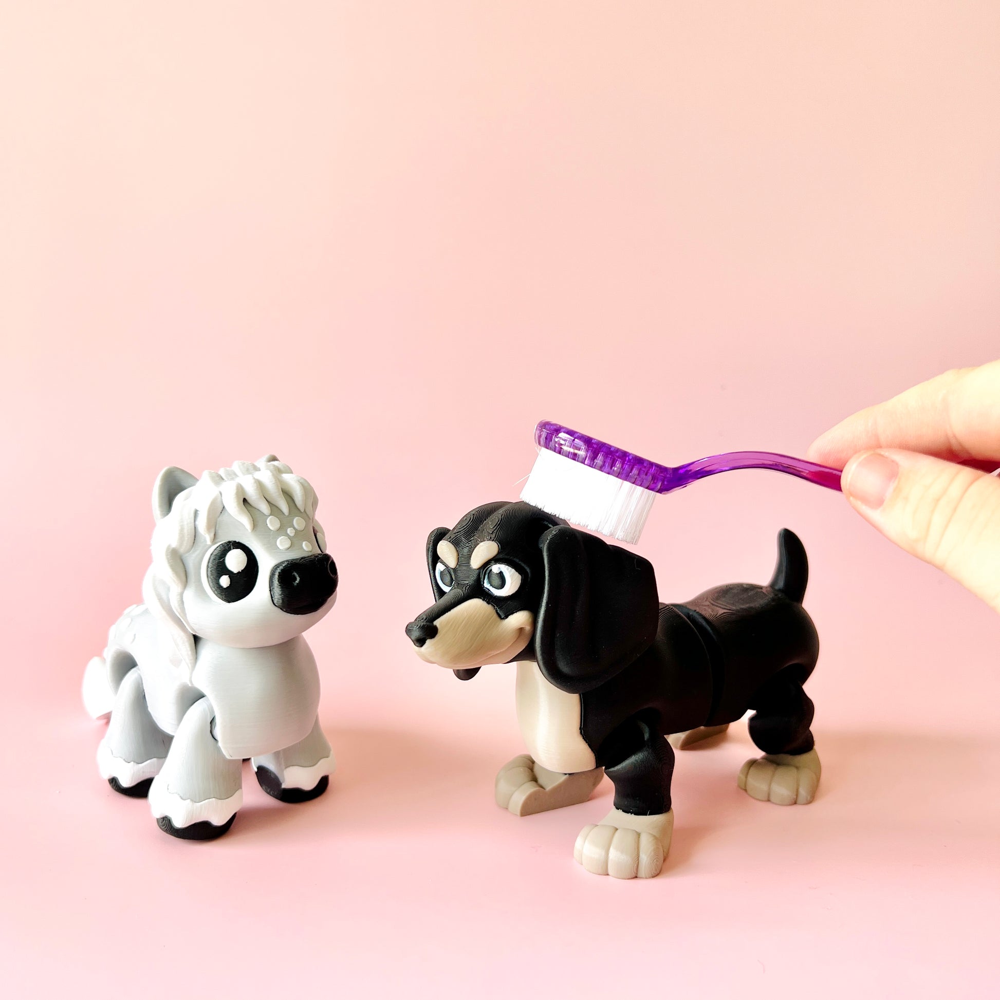 Two playful figurines, a white wolf and a black dachshund, with a toothbrush held above the dachshund's head.