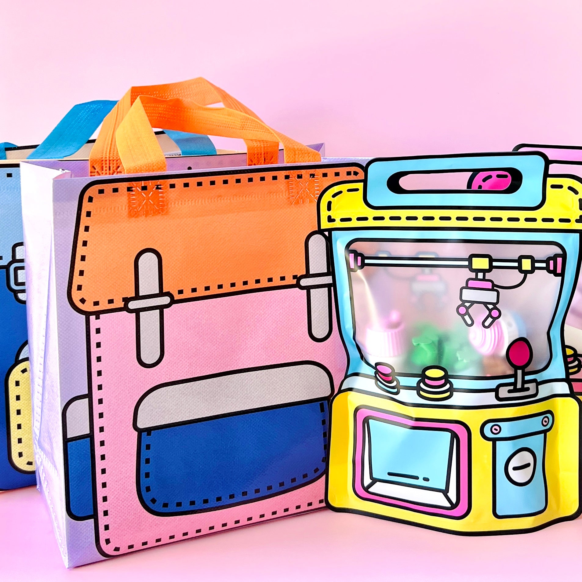 Colorful bags featuring playful cartoon designs with bright handles against a soft pink background.