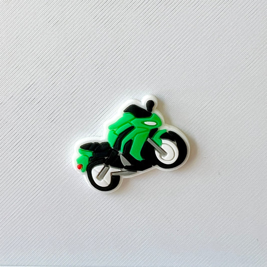 A vibrant green motorcycle with black accents, set against a textured white background.